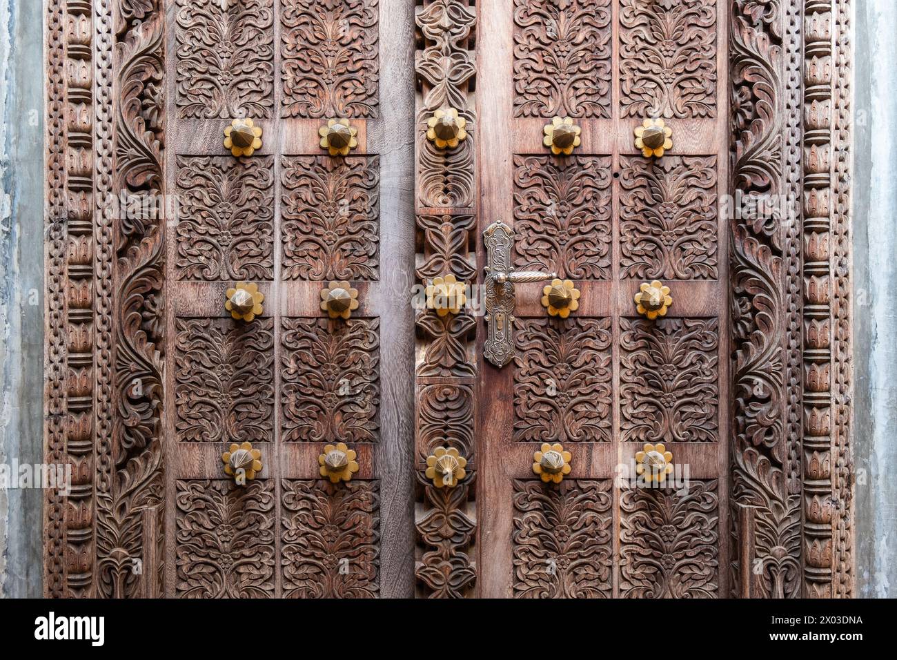 An Arab culture inspired elaborately carved door with an ornate door handle at the entrance to a building in Zanzibar, Tanzania. Stock Photo
