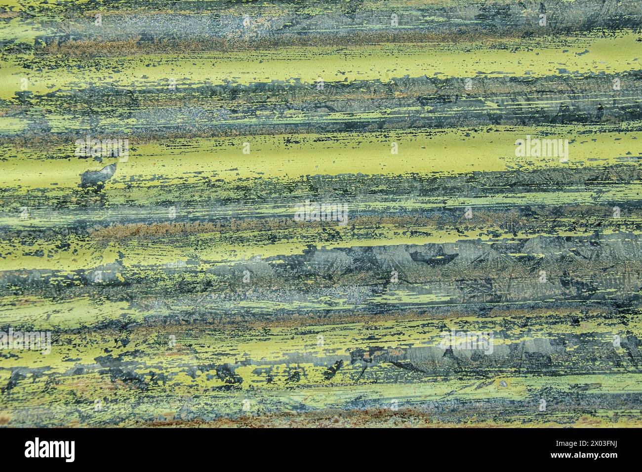 Lime green painted corrugated iron, the remains of civilisation in the abandoned Bogenfels mining town in Namibia. Stock Photo