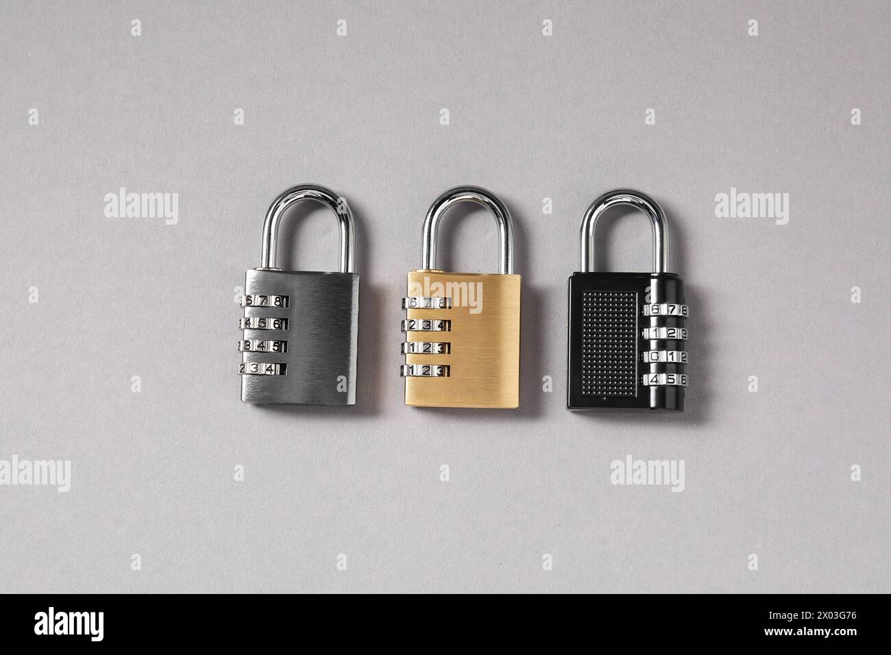 Steel combination padlocks on grey background, top view Stock Photo