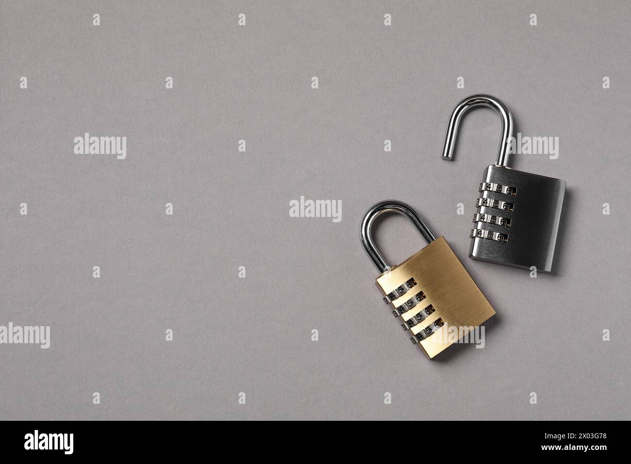 Steel combination padlocks on grey background, top view. Space for text Stock Photo