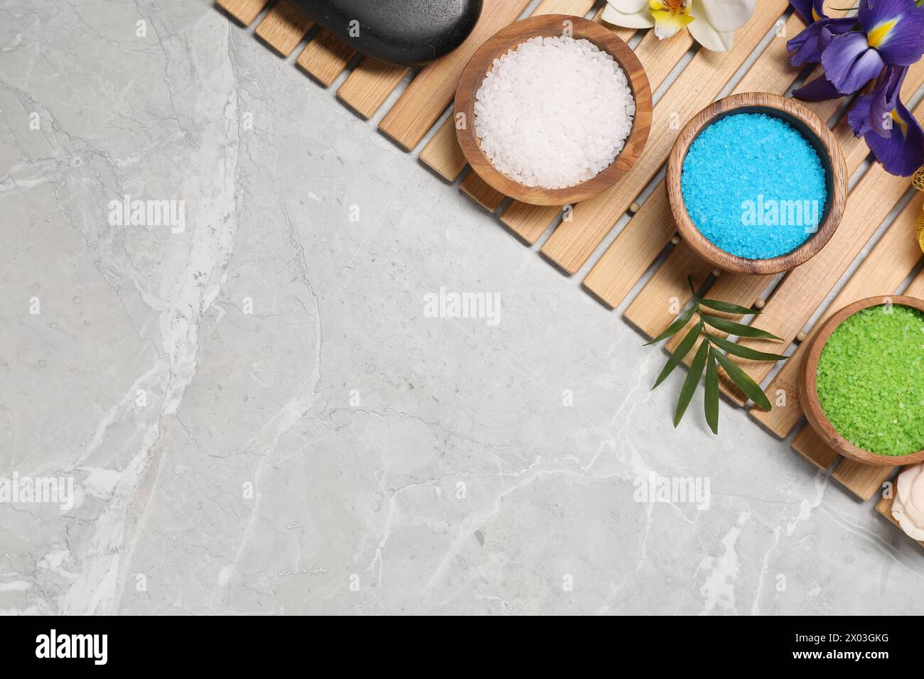 Flat lay composition with natural sea salt on grey marble table. Space ...