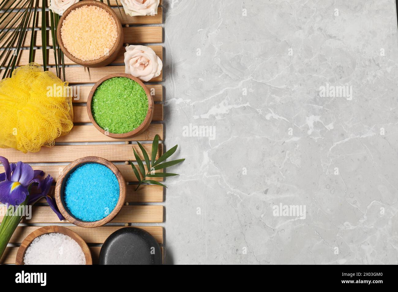 Flat lay composition with natural sea salt on grey marble table. Space ...