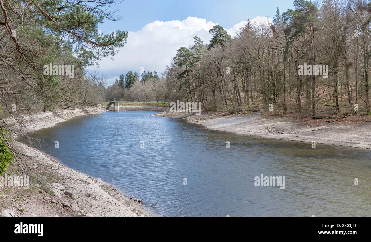 landscape with soil dyke of lake among woods at historical public park, shot in spring light at Stuttgart, Germany Stock Photo