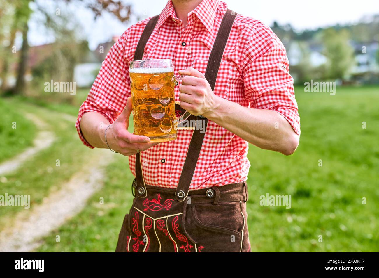 Mit Bier Bavaria, Germany - April 7, 2024: A man in lederhosen and traditional ...