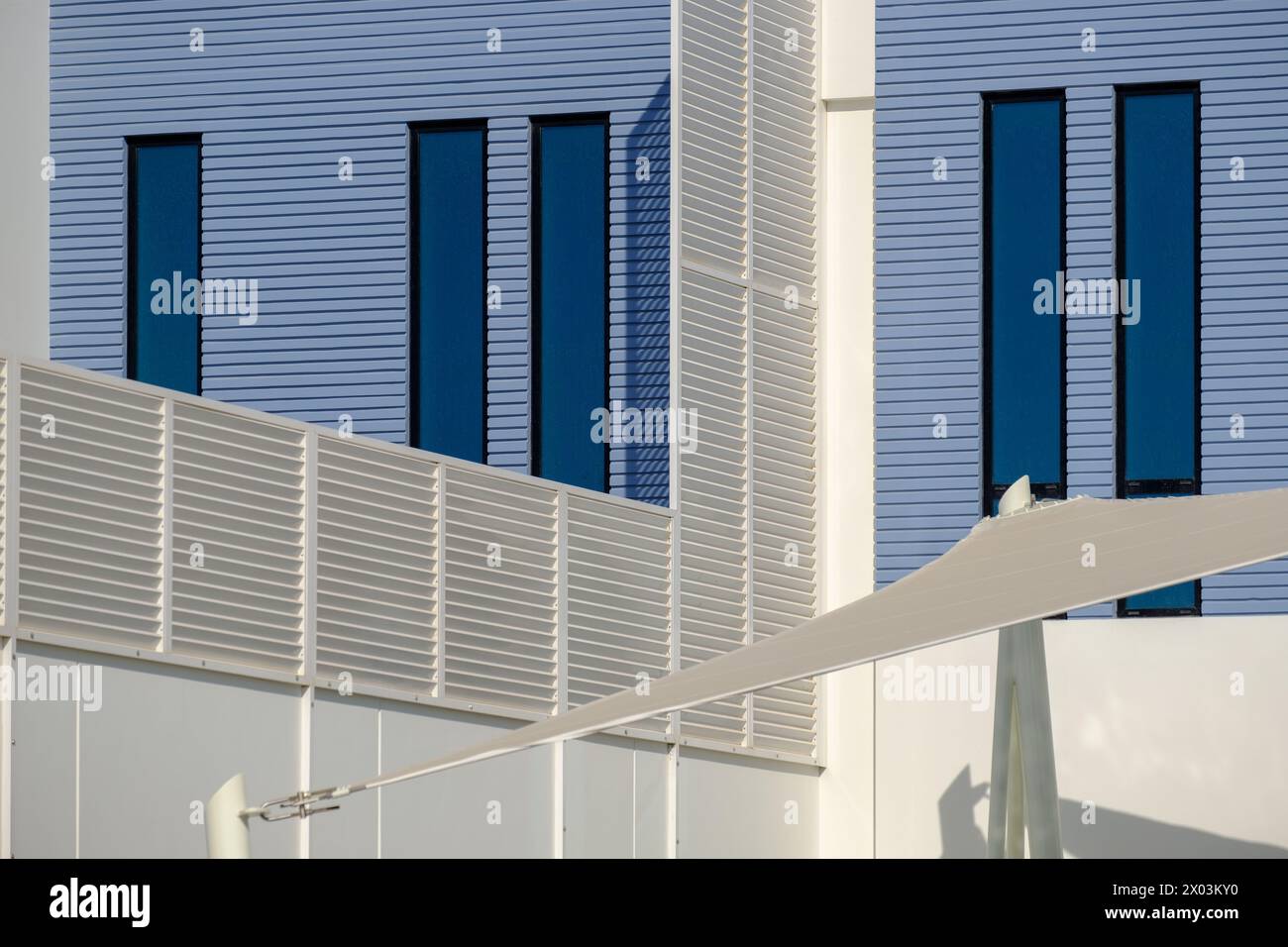 Detail of a white and blue modern villa in a Middle Eastern, high-end, luxury housing development on a sunny day with strong shadows. Stock Photo