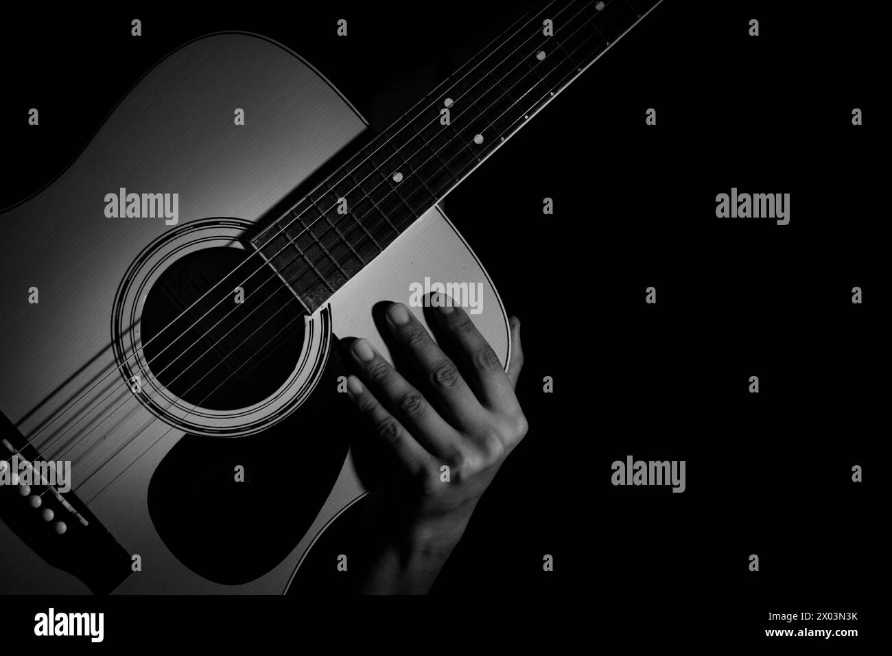 Man holding acoustic guitar. Music background Stock Photo