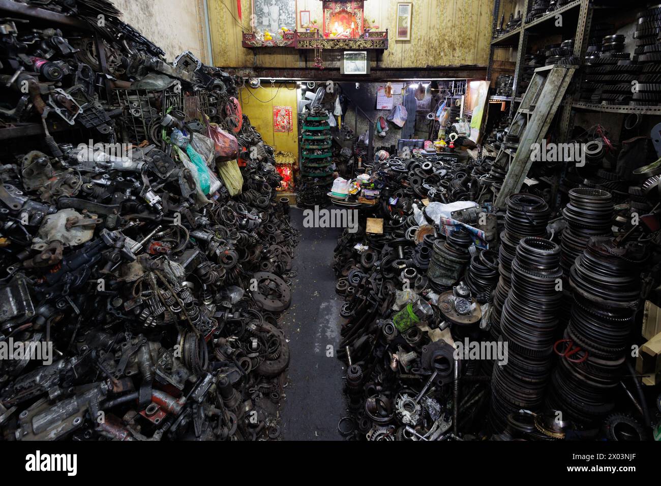 A vehicle shop filled with old parts and tools, the atmosphere is chaotic and disorganized, Bangkok's Chinatown, Thailand Stock Photo