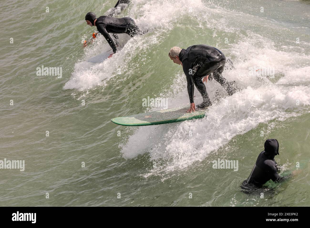 Bournemouth Dorset 9th Apr 2024 UK Weather; visitors enjoy the spring sunshine despite the high winds and large swell from overnight storms. Surfing Credit: Ian Davidson/Alamy Live News Stock Photo