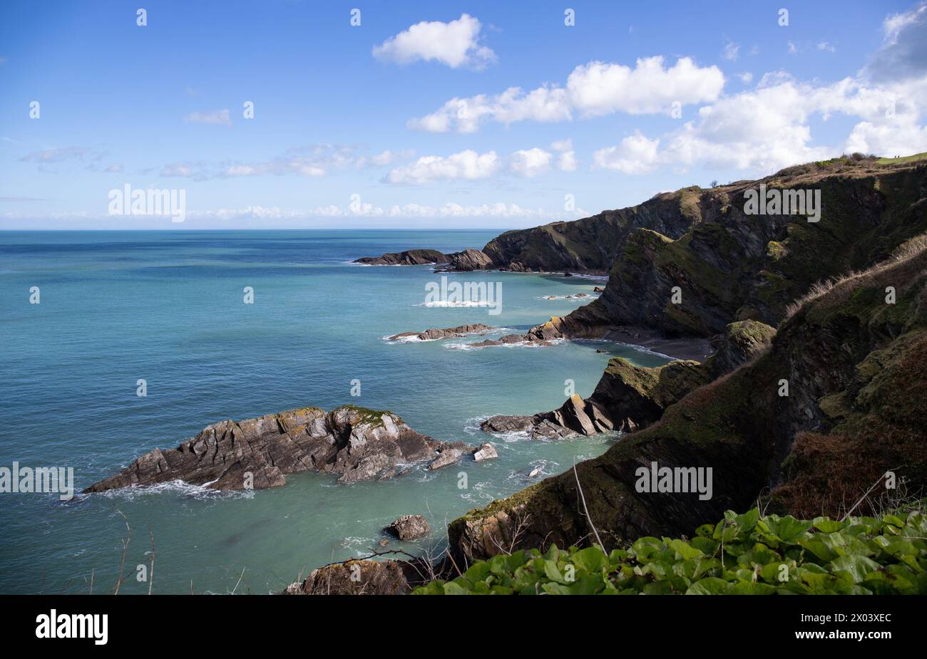 Cliffs stretching to the blue ocean in Combe Martin, Devon, England Stock Photo