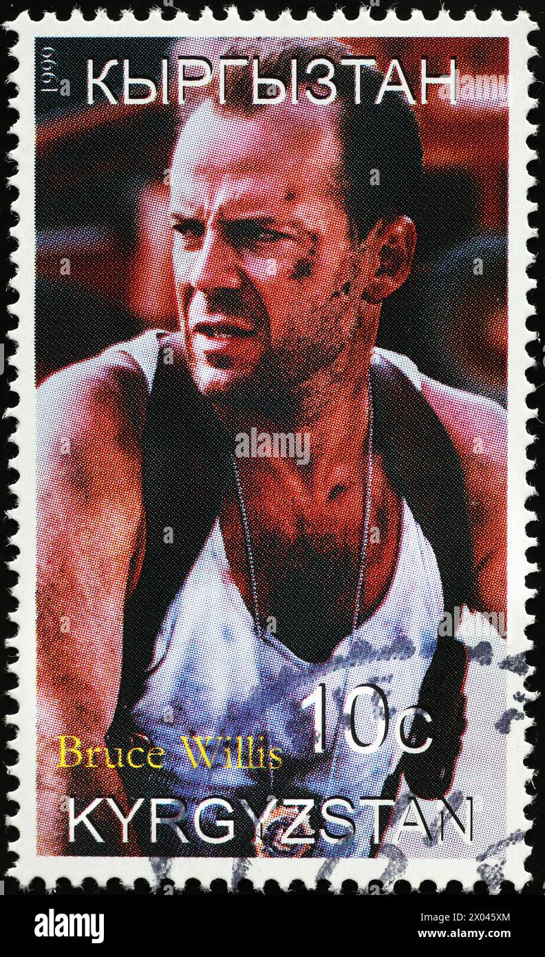 Bruce Willis in an action movie on postage stamp Stock Photo