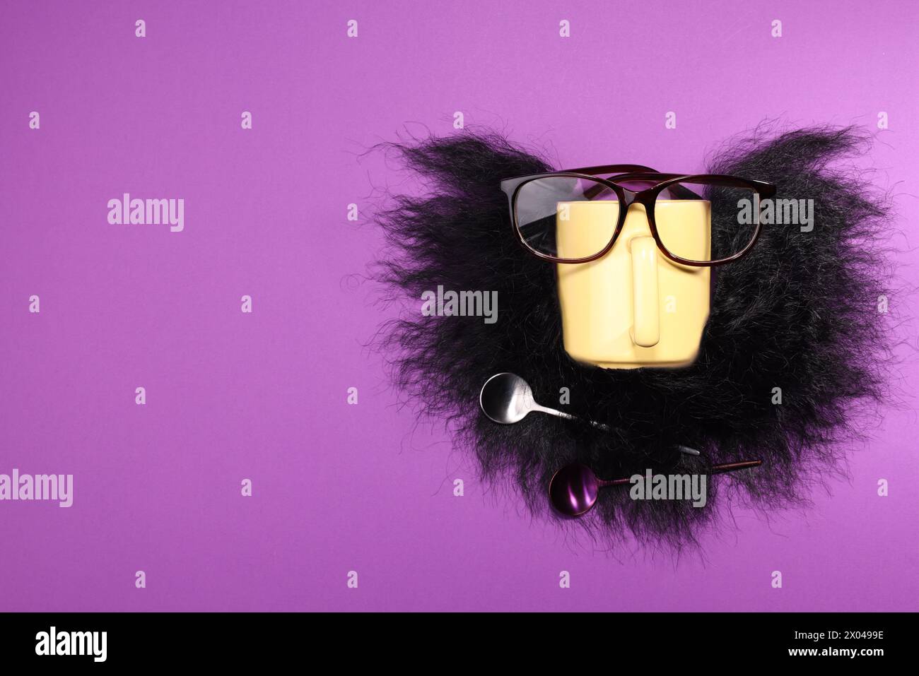 Man's face made of artificial beard, cup and glasses on purple background, top view. Space for text Stock Photo
