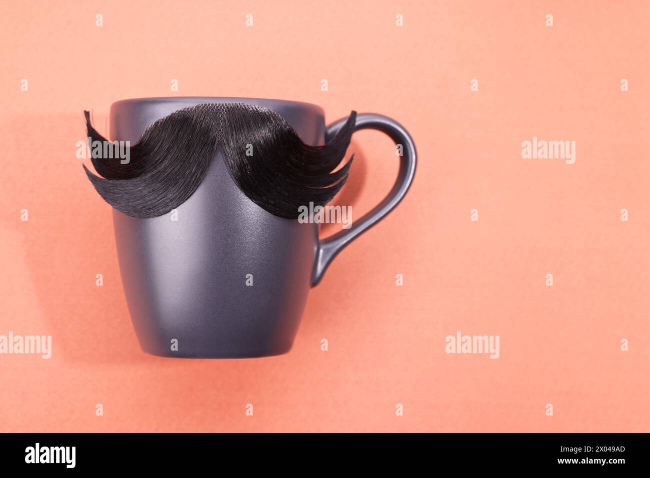 Man's face made of artificial mustache and cup on pink background, top view. Space for text Stock Photo