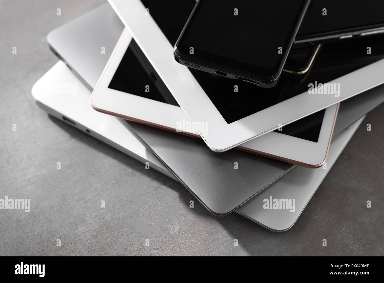 Many different modern gadgets on grey table, closeup Stock Photo