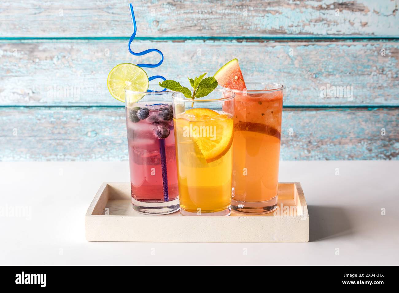 Three refreshing seltzers with various fruit garnishments. Stock Photo