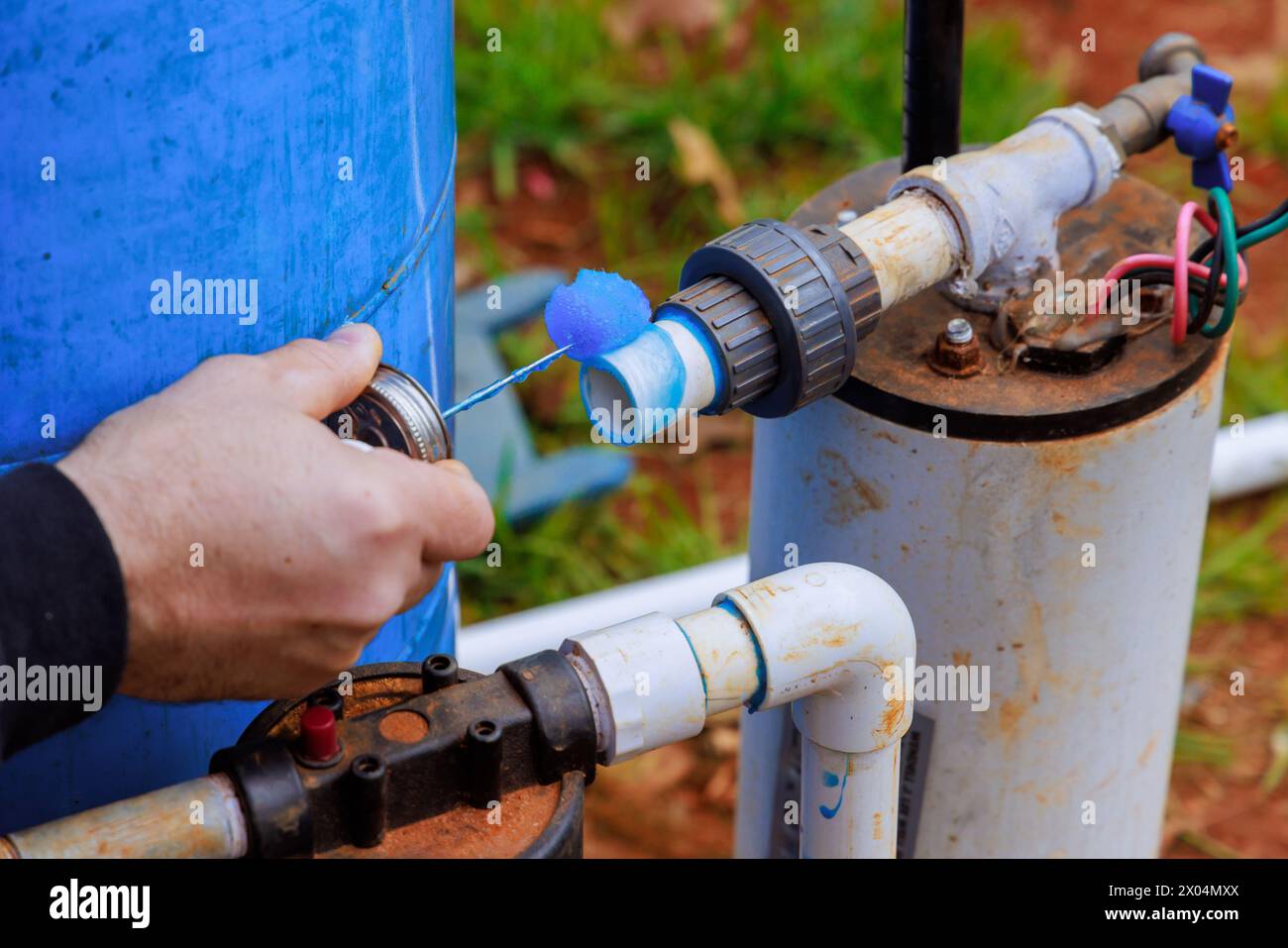 Plumber putting glue on pvc pipe before gluing Stock Photo Alamy