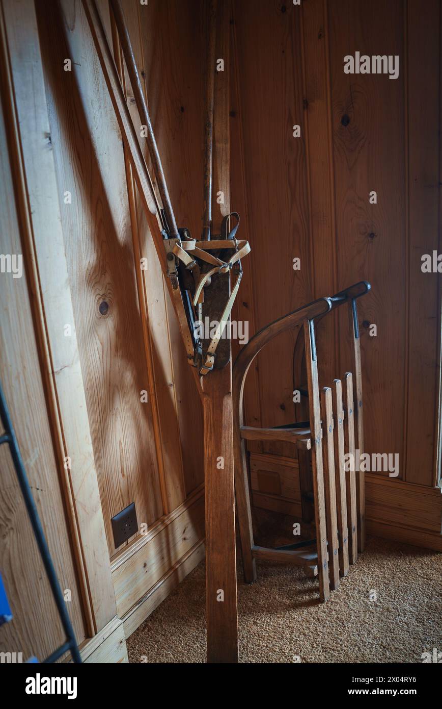 Rustic Winter Decor with Vintage Skis and Sled in a Cozy Room Stock Photo