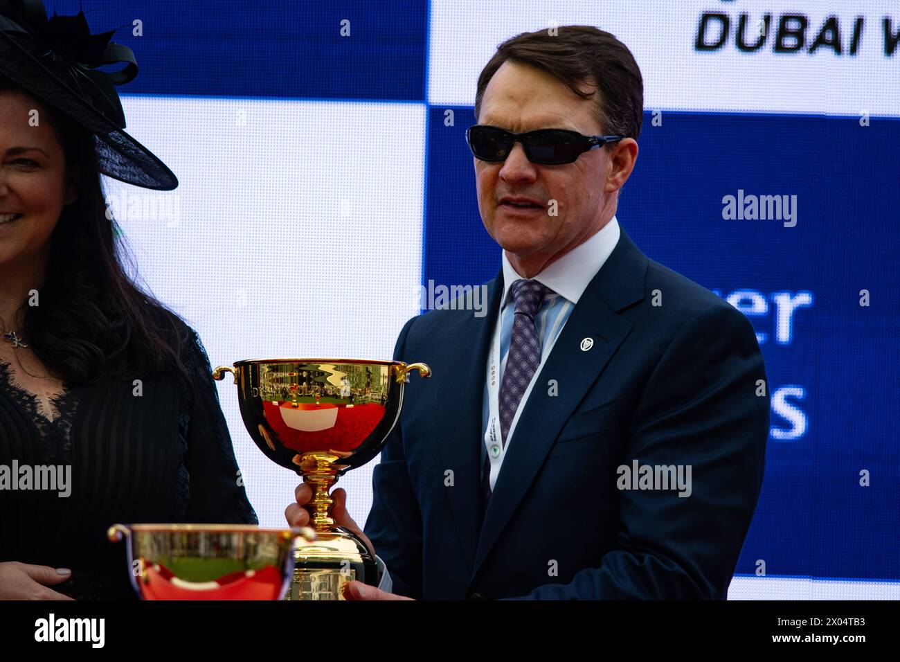 Dubai, United Arab Emirates. Saturday 30th March 2024. Trainer Aidan O'Brien collects his trophy after Tower Of London won the Group 2  Dubai Gold Cup Stock Photo