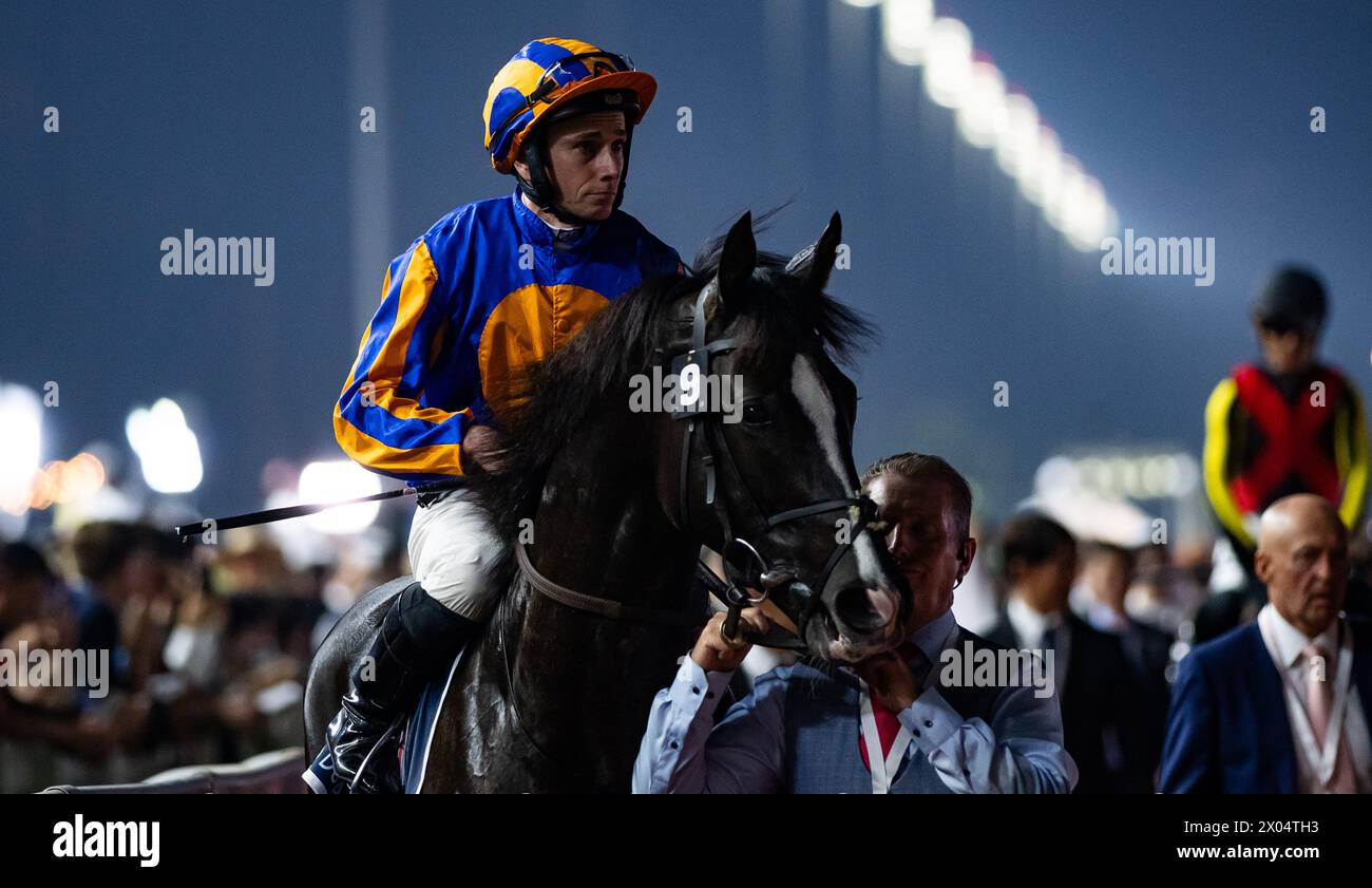 Auguste Rodin and jockey Ryan Moore head to the start for the Longines Sheema Classic, 30/03/24, Meydan Racecourse. Credit JTW Equine Images / Alamy. Stock Photo