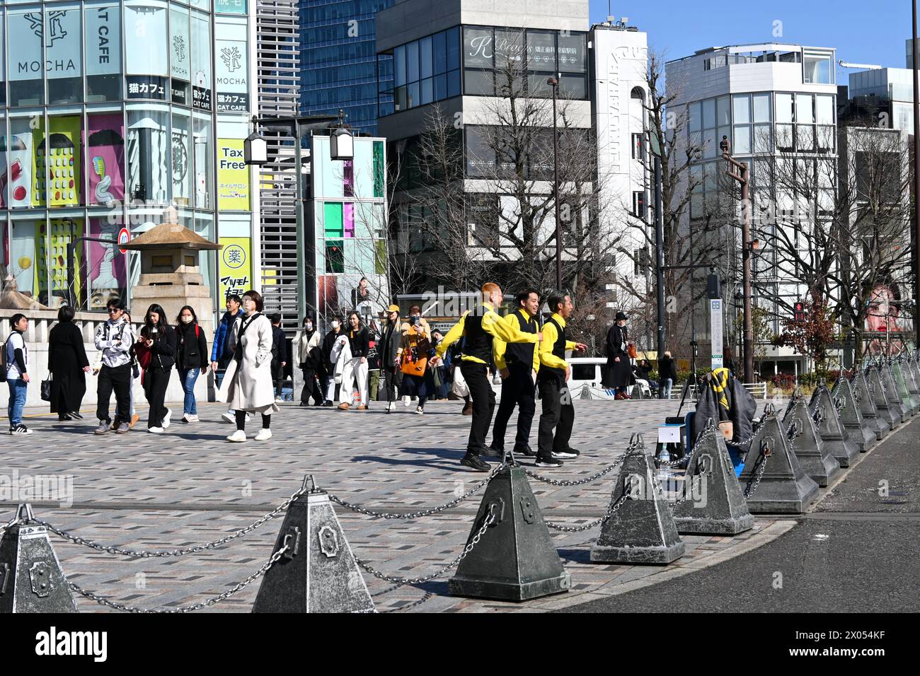 Men in yellow shirts dancing on Jingūbashi (Shrine Bridge) in Harajuku - Jingumae, Shibuya City, Tokyo, Japan – 01 March 2024 Stock Photo