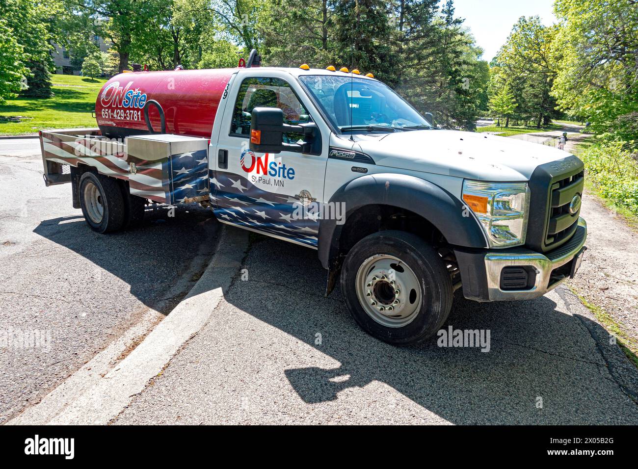 Onsite pump truck for emptying portable outhouses for walkers runners bikers on the North Mississippi River Boulevard. St Paul Minnesota MN USA Stock Photo