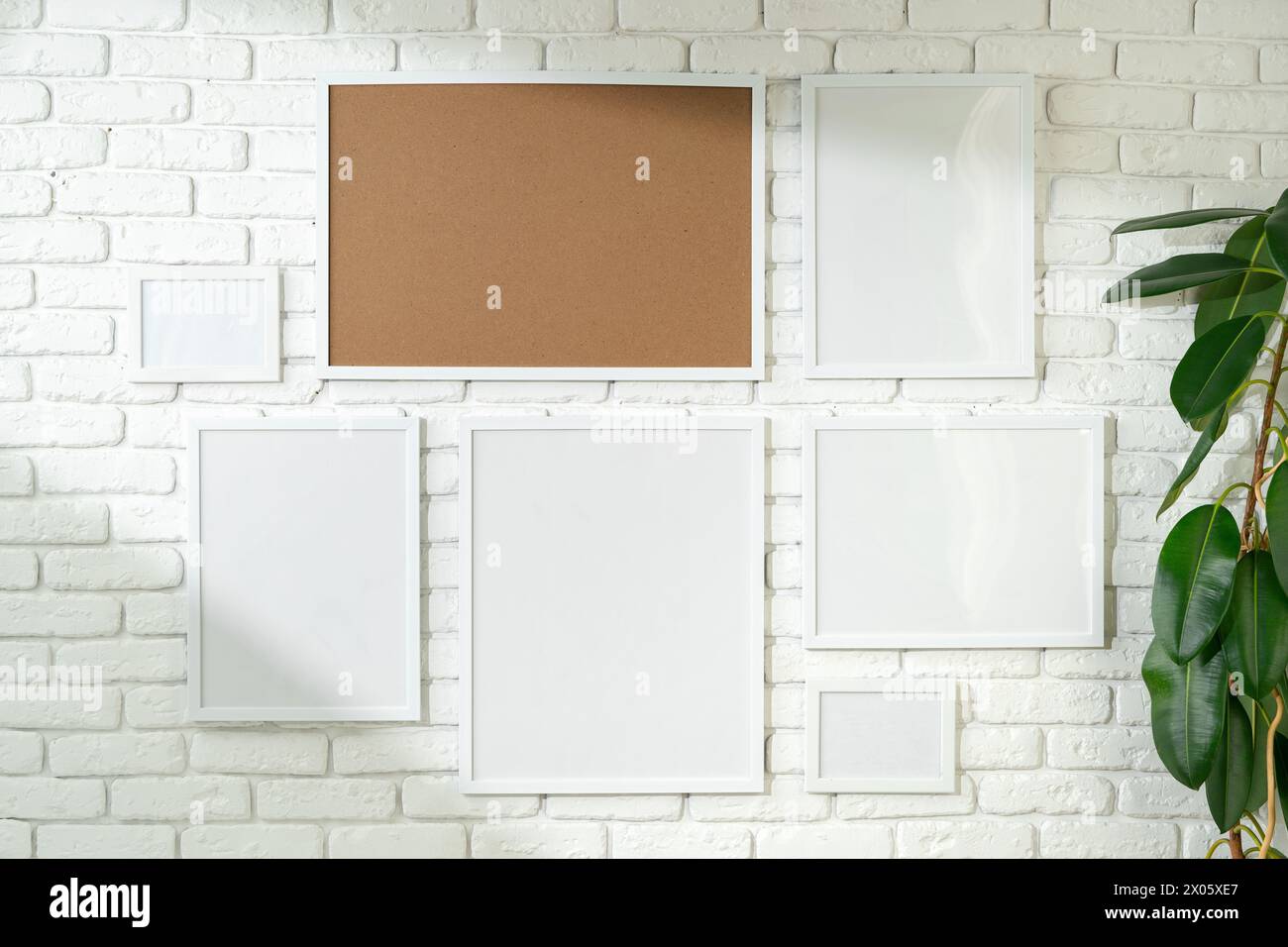 Varied Sized Photo Frames Displayed on a White Brick Wall Stock Photo ...