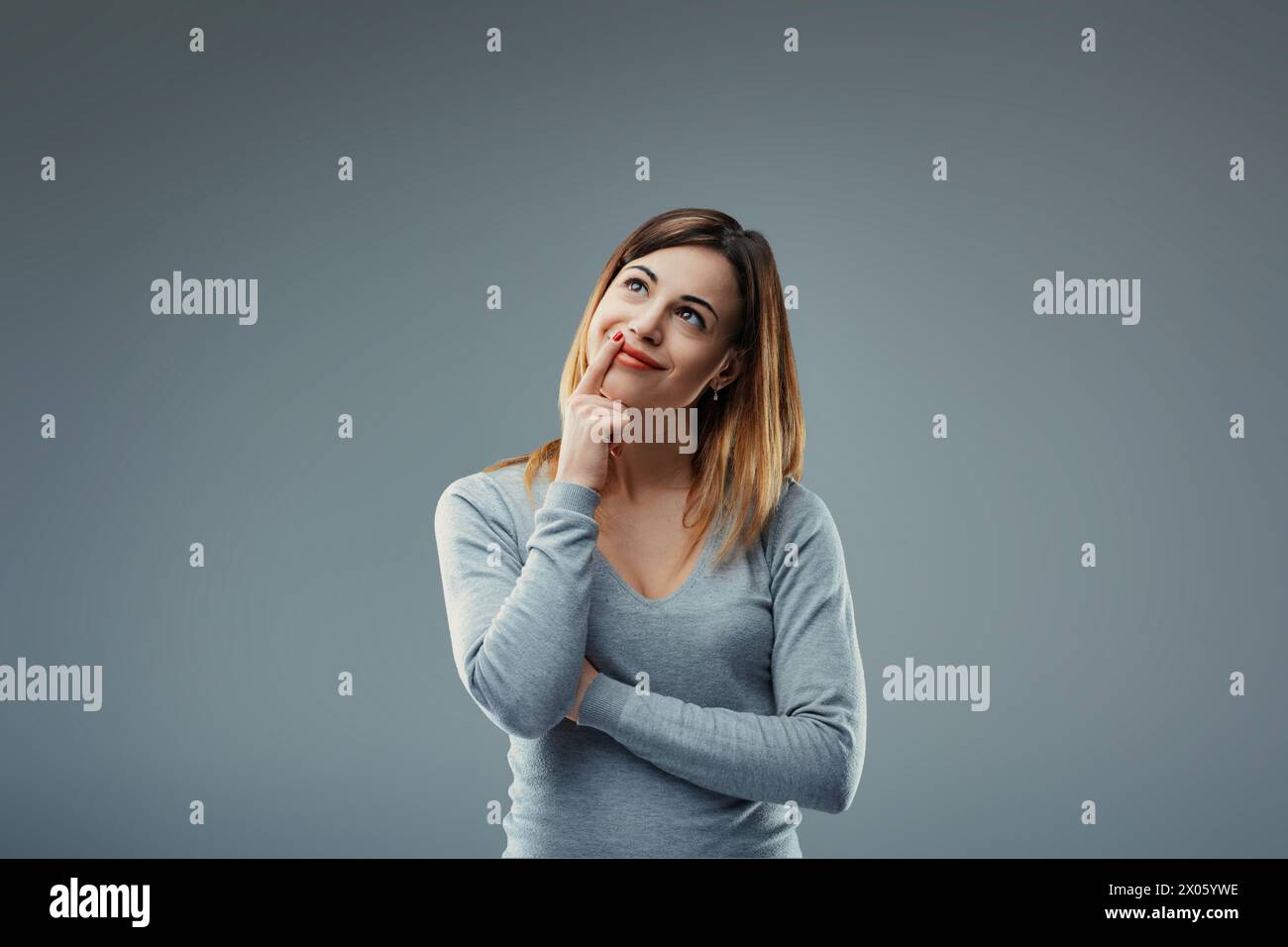 Engrossed in her thoughts, the woman's reflective pause hints at inner ...