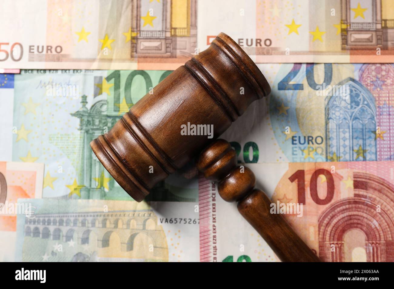 Tax law. Wooden gavel on euro banknotes, top view Stock Photo