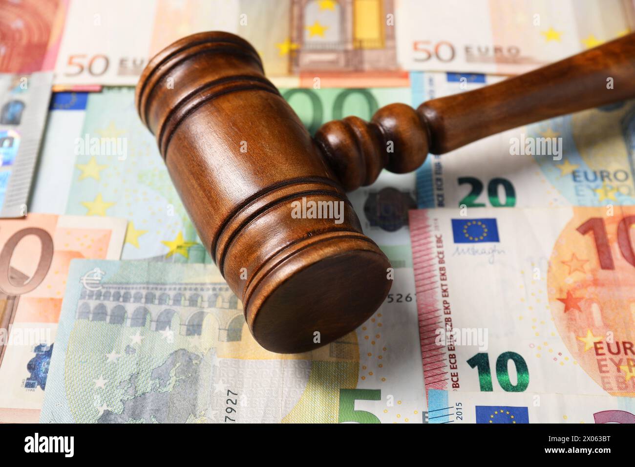 Tax law. Wooden gavel on euro banknotes, closeup Stock Photo