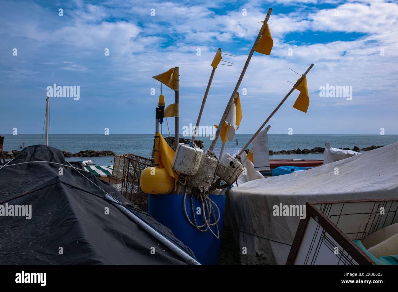 Fishing floats with yellow flags. Equipment for sea fishing on the seashore on a sunny day. Stock Photo