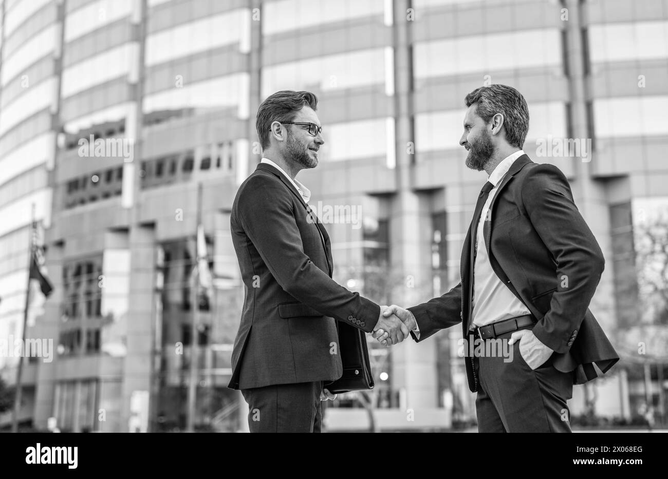 Handshake meeting two businessmen Black and White Stock Photos & Images ...