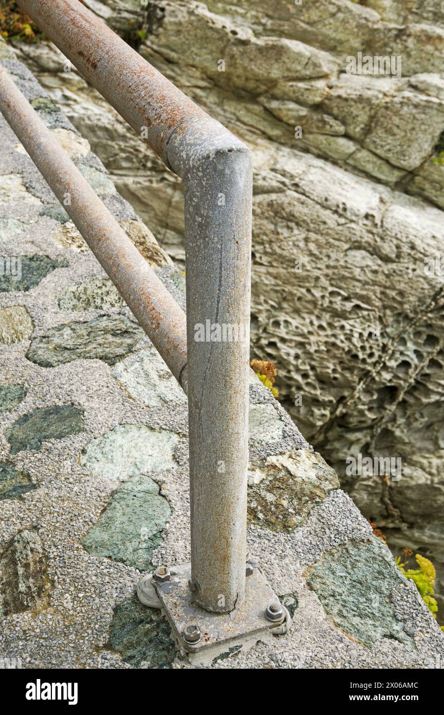 metal railing along a pathway at the edge of rocky cliff, Liguria, Italy Stock Photo