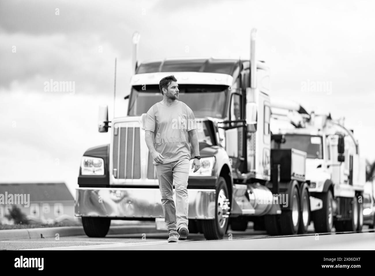 Highway engineer walking on highway. Man wearing safety vest for traffic work. Highway engineering Stock Photo