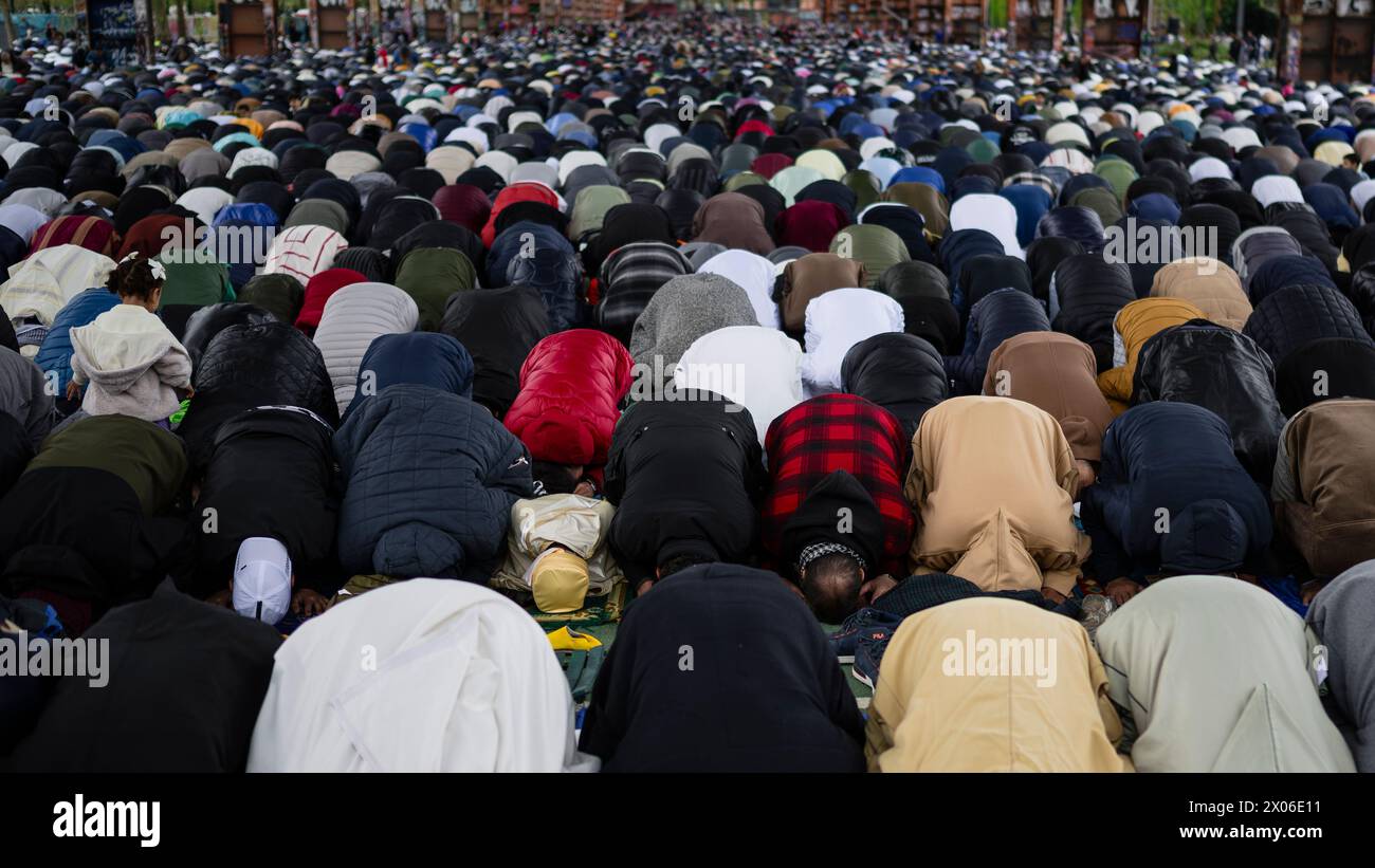 Turin, Italy. 10 April 2024. Members of the Muslim community pray in 'Parco Dora' as part of Eid al-Fitr celebrations. Eid al-Fitr is celebrated by Muslims worldwide because it marks the end of the month of Ramadan. Credit: Nicolò Campo/Alamy Live News Stock Photo