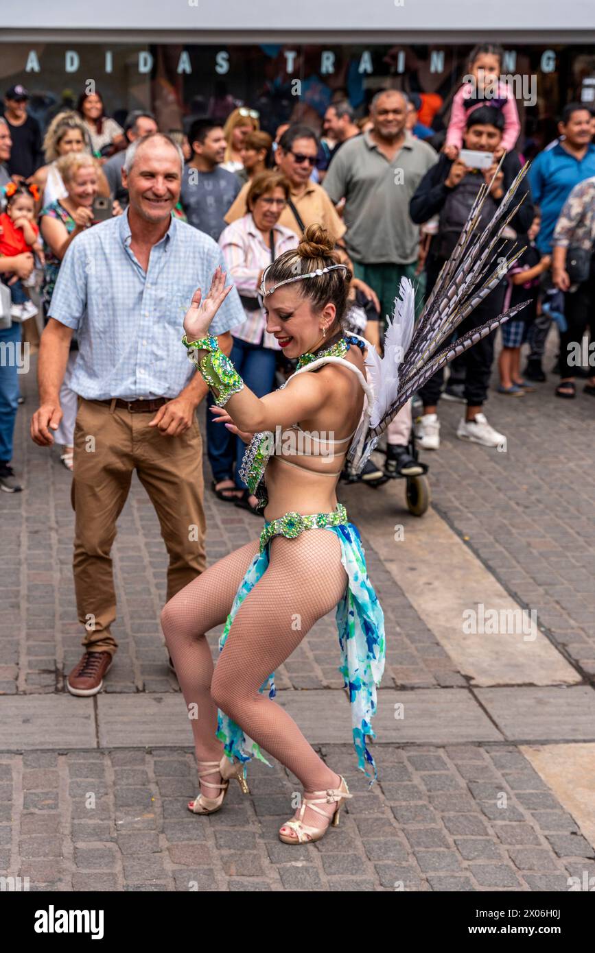 A Young Woman Dancing In The Street With A Spectator During The Salta Carnival, Salta Province, Argentina Stock Photo
