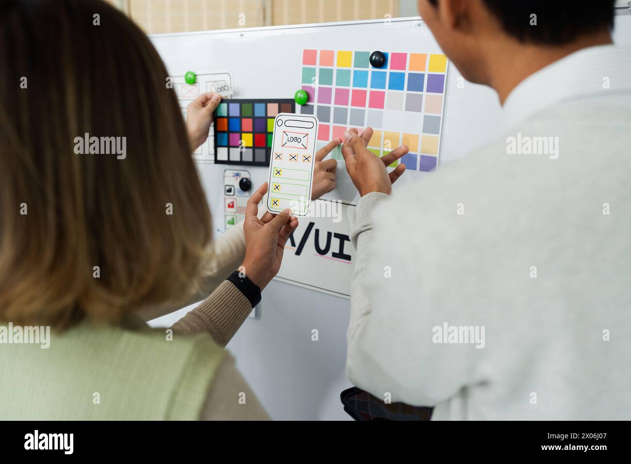Close up ux developer and ui designer brainstorming interface wireframe design.Creative digital development agency Stock Photo