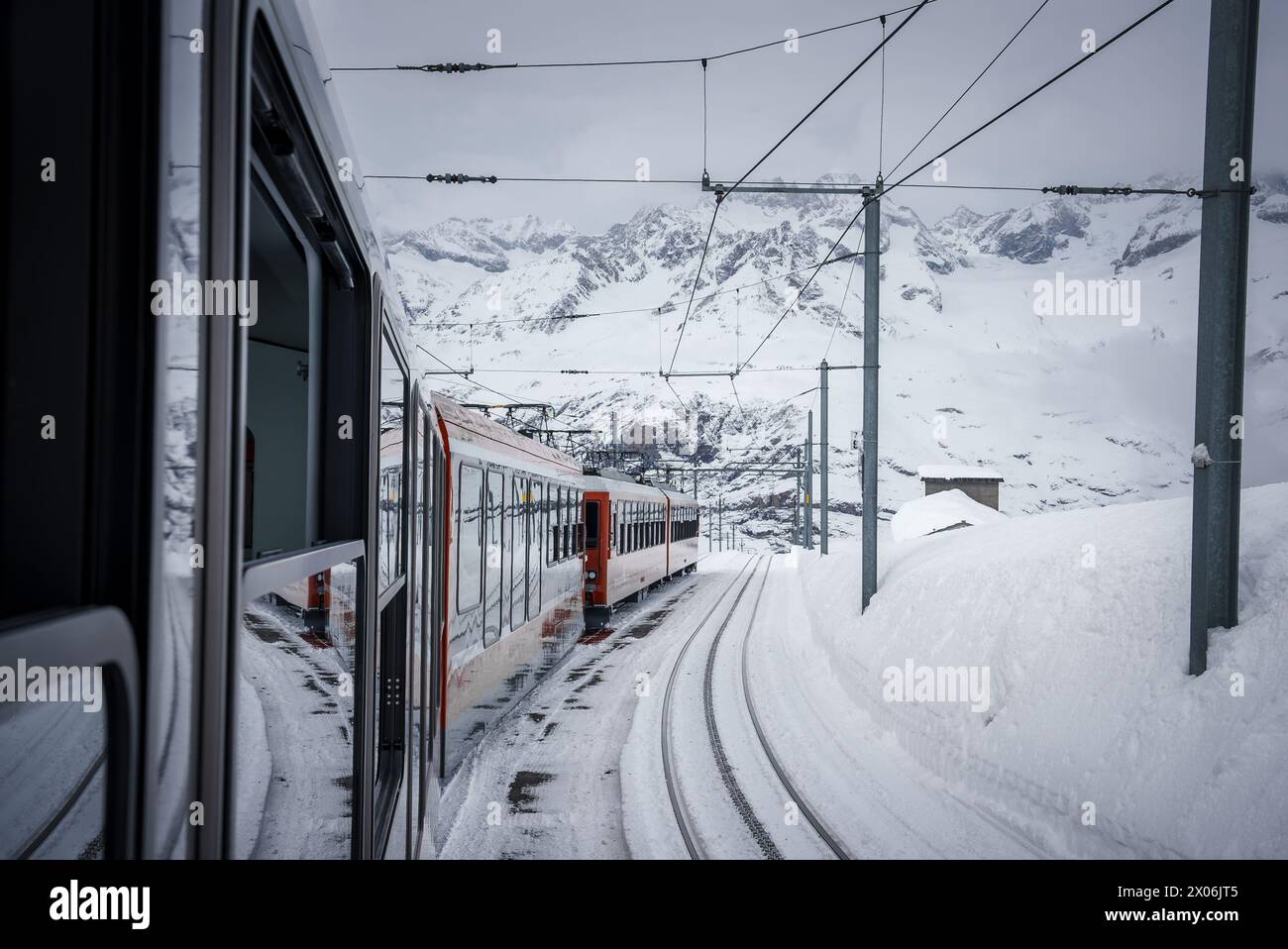 Winter journey through Zermatt ski resort on Swiss railway. Stock Photo