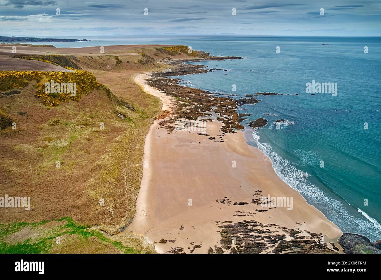 Sunnyside Beach Cullen Scotland a sand beach with rocks and the Moray Firth with a calm sea in the evening Stock Photo