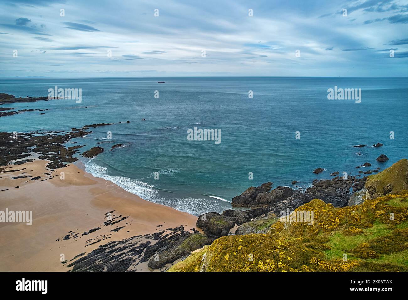 Sunnyside Beach Cullen Scotland sandy beach with rocks and the Moray Firth with a calm sea in the evening Stock Photo