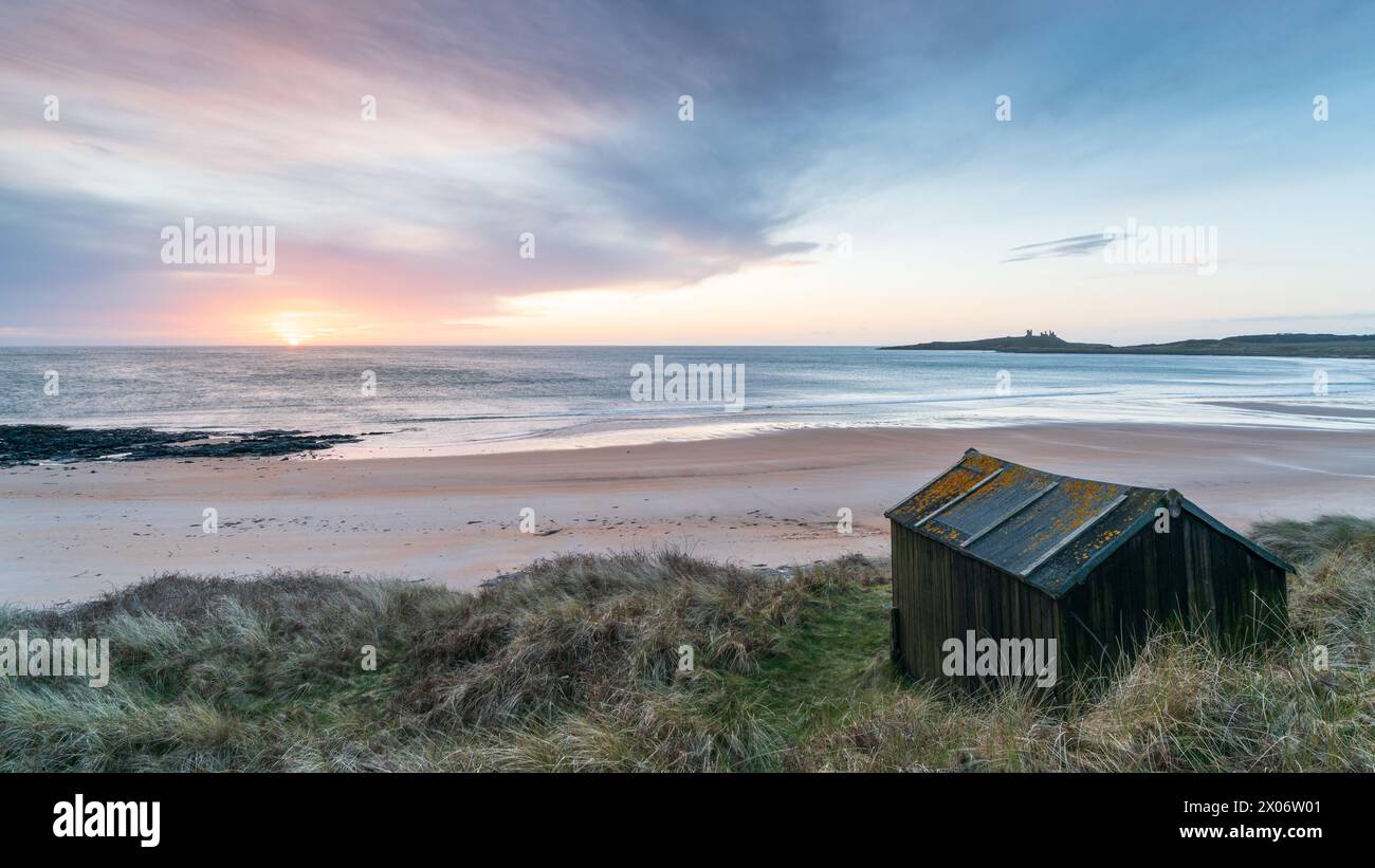 A soft sunrise frames Embleton Bay on a chilly morning in early spring ...