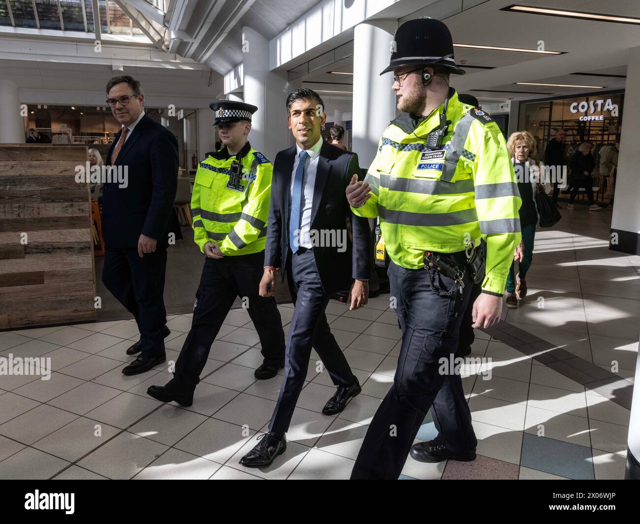 Prime Minister Rishi Sunak (centre) walks through Swan Walk shopping ...