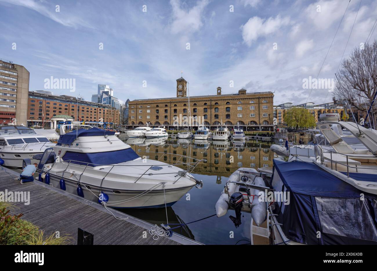 Boats in St Kathrine's Dock marina. Back: Ivory House and hotels, shops, cafes, restaurants, residential by River Thames in Tower Hamlets, London. Stock Photo