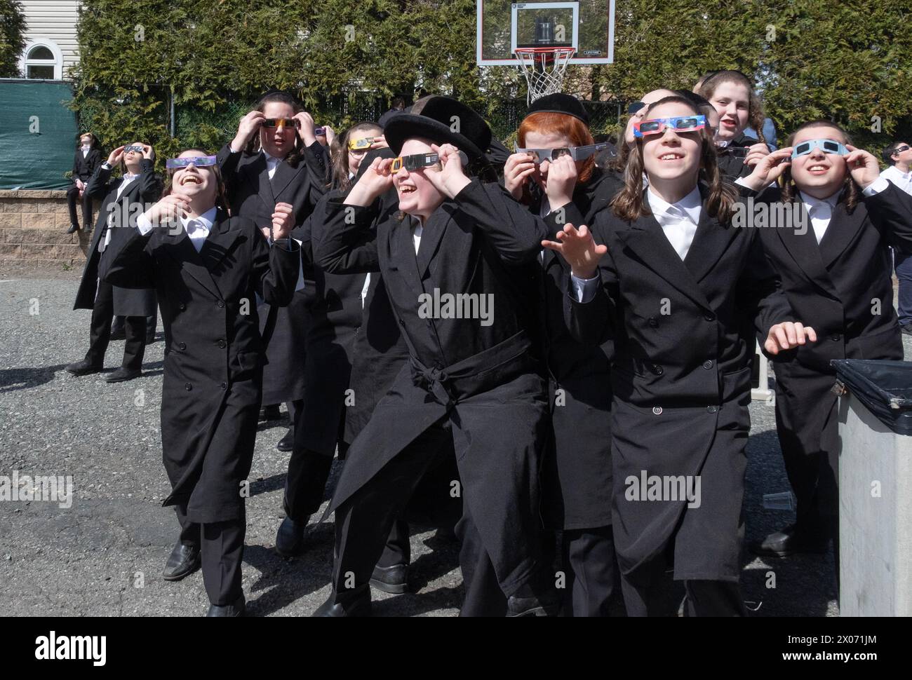 A group of orthodox Jewish boys watch the 2024 solar eclipse from the