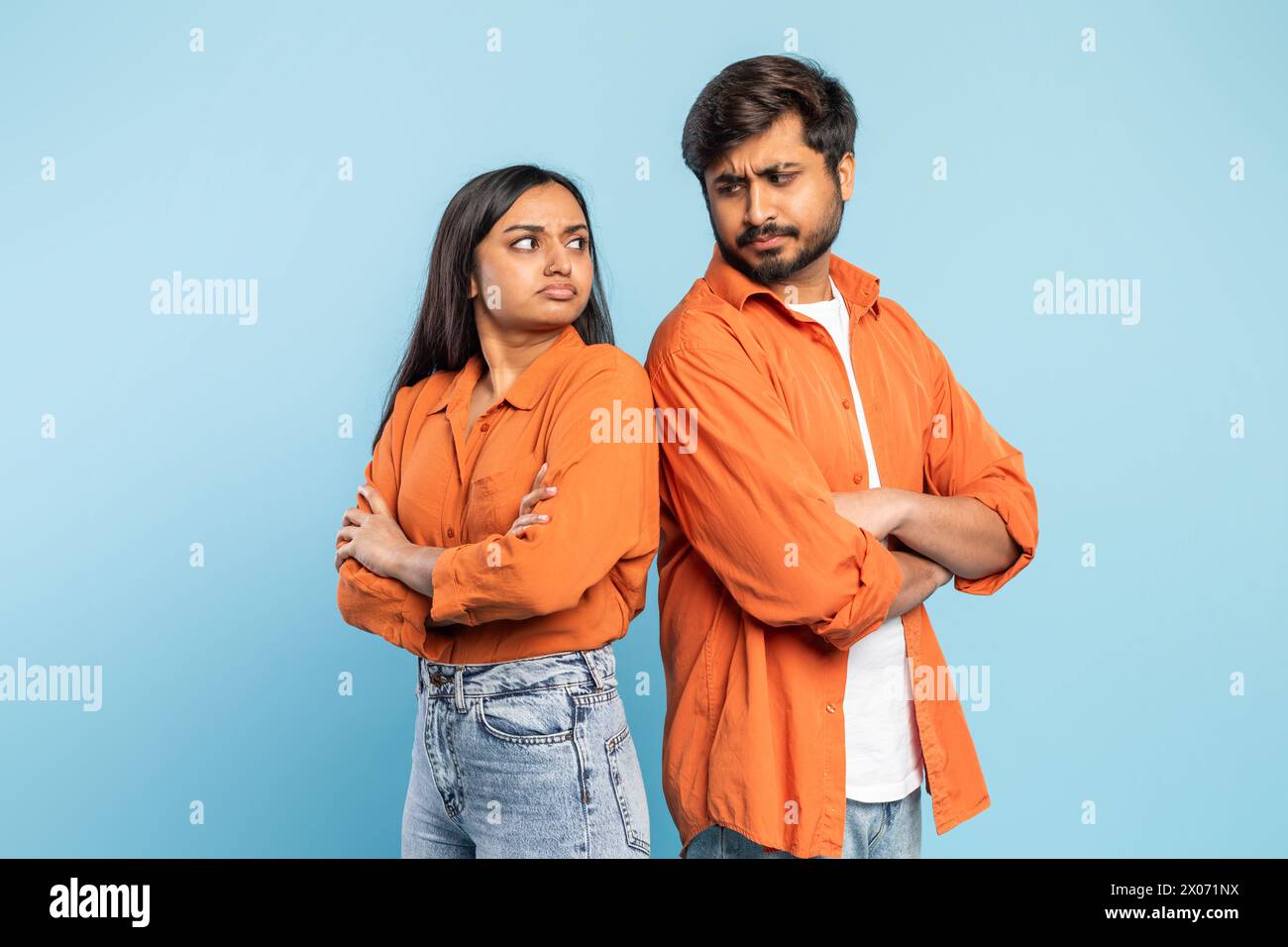Couple with arms crossed in disagreement on blue background Stock Photo