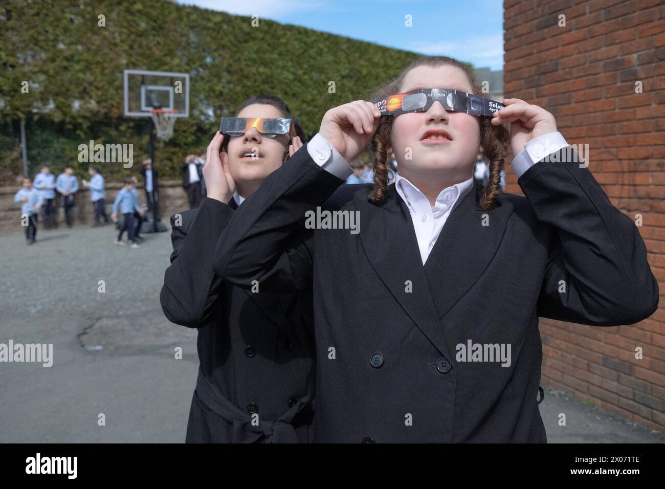 Two Hasidic Jewish boys watch the 2024 Solar Eclipse in their