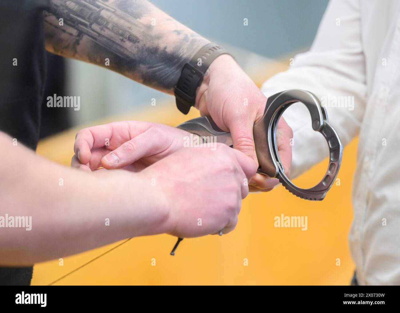 hanover-germany-10th-apr-2024-the-accused-is-handcuffed-in-hanover