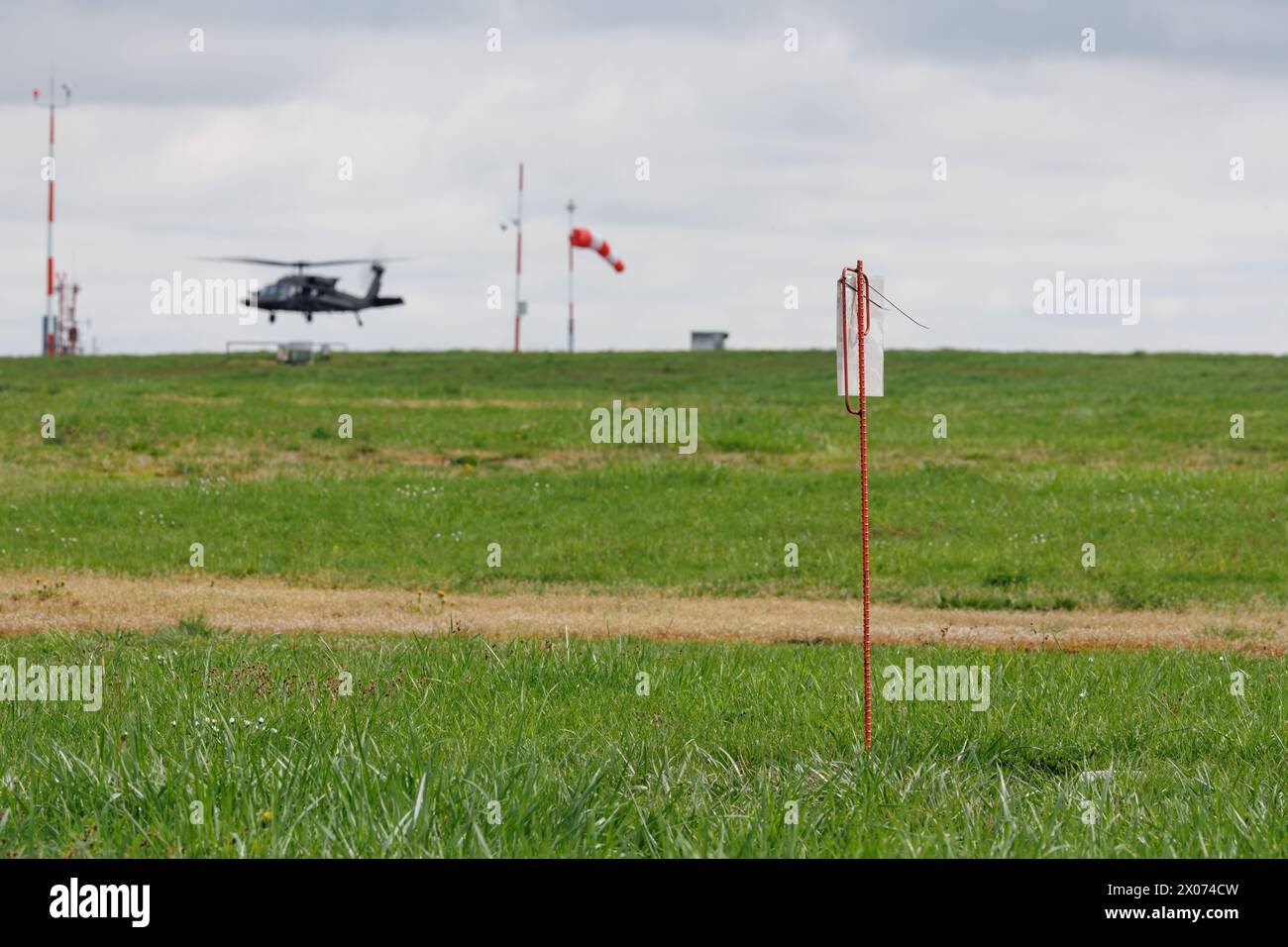 Katterbach, Germany. 10th Apr, 2024. An iron rod marks a production well on the airfield at the US military airfield Katterbach Airfield near Ansbach in the immediate vicinity of a source of damage caused by perfluorinated and polyfluorinated chemicals (PFAS). In 2014, so-called PFAS were detected on the site, which originated from fire-fighting foam used on a former fire-fighting training area. Remediation measures have now begun to prevent the contaminated groundwater from spreading and to clean the water. Credit: Daniel Karmann/dpa/Alamy Live News Stock Photo