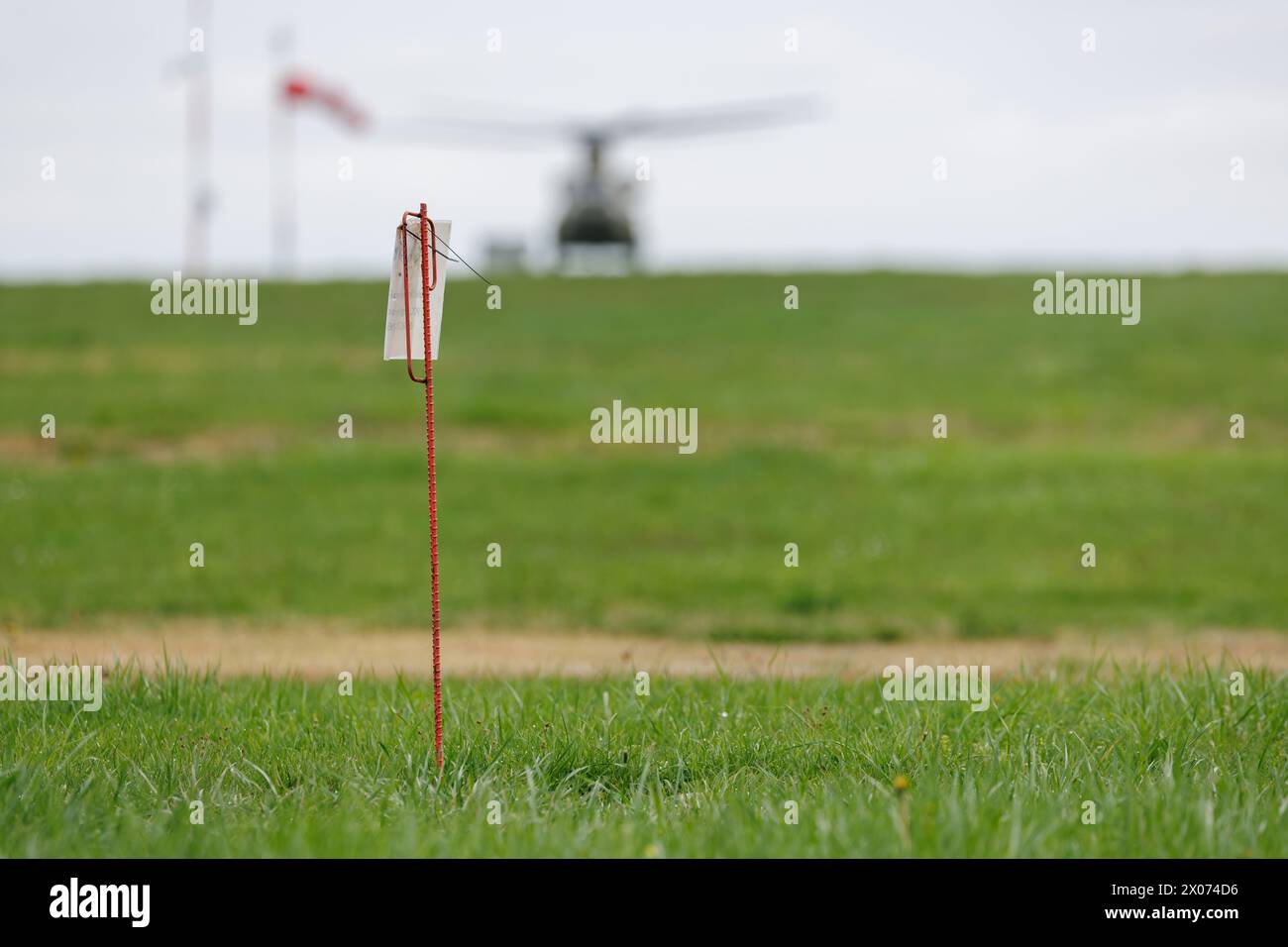 Katterbach, Germany. 10th Apr, 2024. An iron rod marks a production well on the airfield at the US military airfield Katterbach Airfield near Ansbach in the immediate vicinity of a source of damage caused by perfluorinated and polyfluorinated chemicals (PFAS). In 2014, so-called PFAS were detected on the site, which originated from fire-fighting foam used on a former fire-fighting training area. Remediation measures have now begun to prevent the contaminated groundwater from spreading and to clean the water. Credit: Daniel Karmann/dpa/Alamy Live News Stock Photo