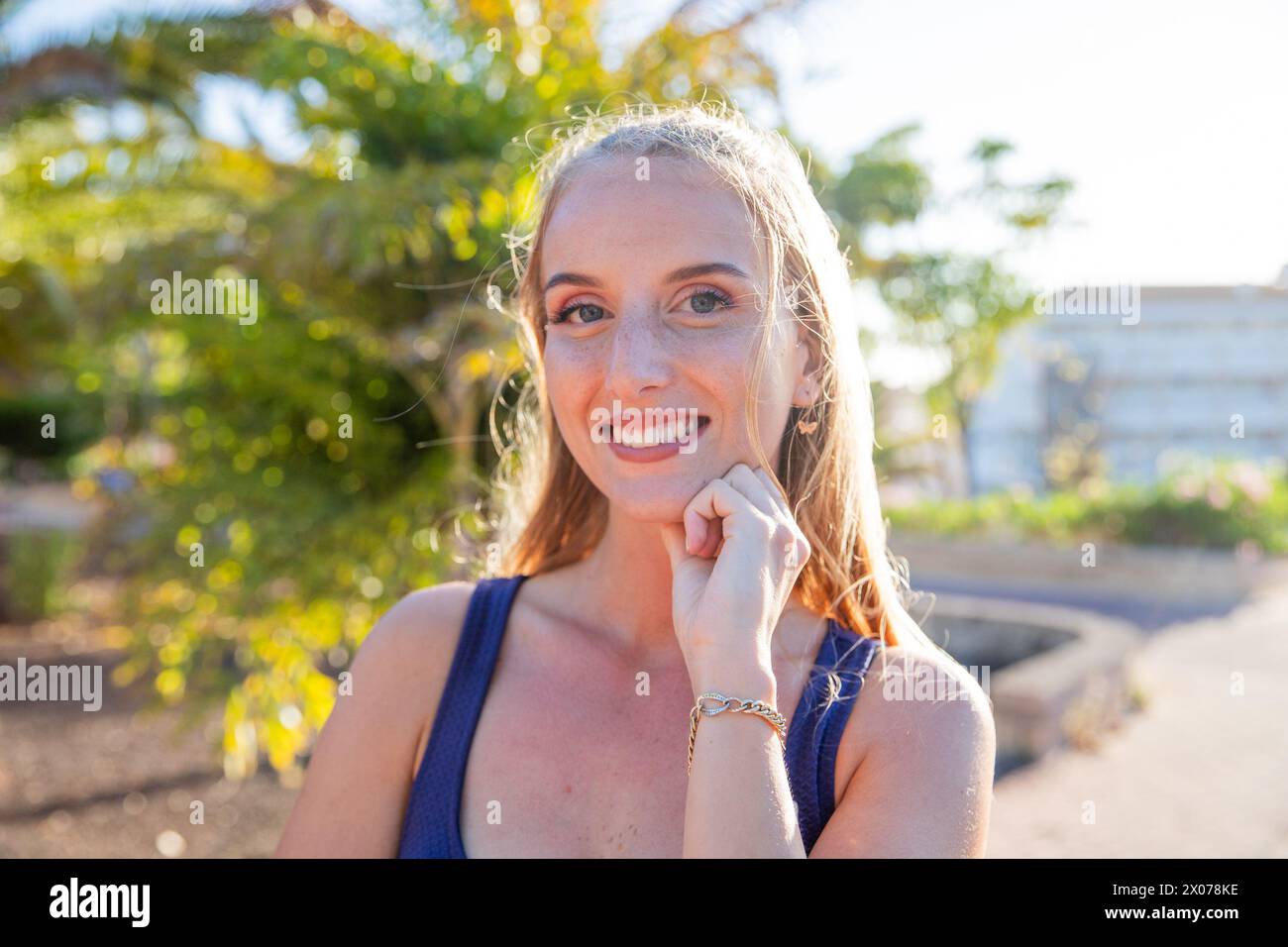 Portrait of a young attractive woman smiling while outdoors in a public park Stock Photo