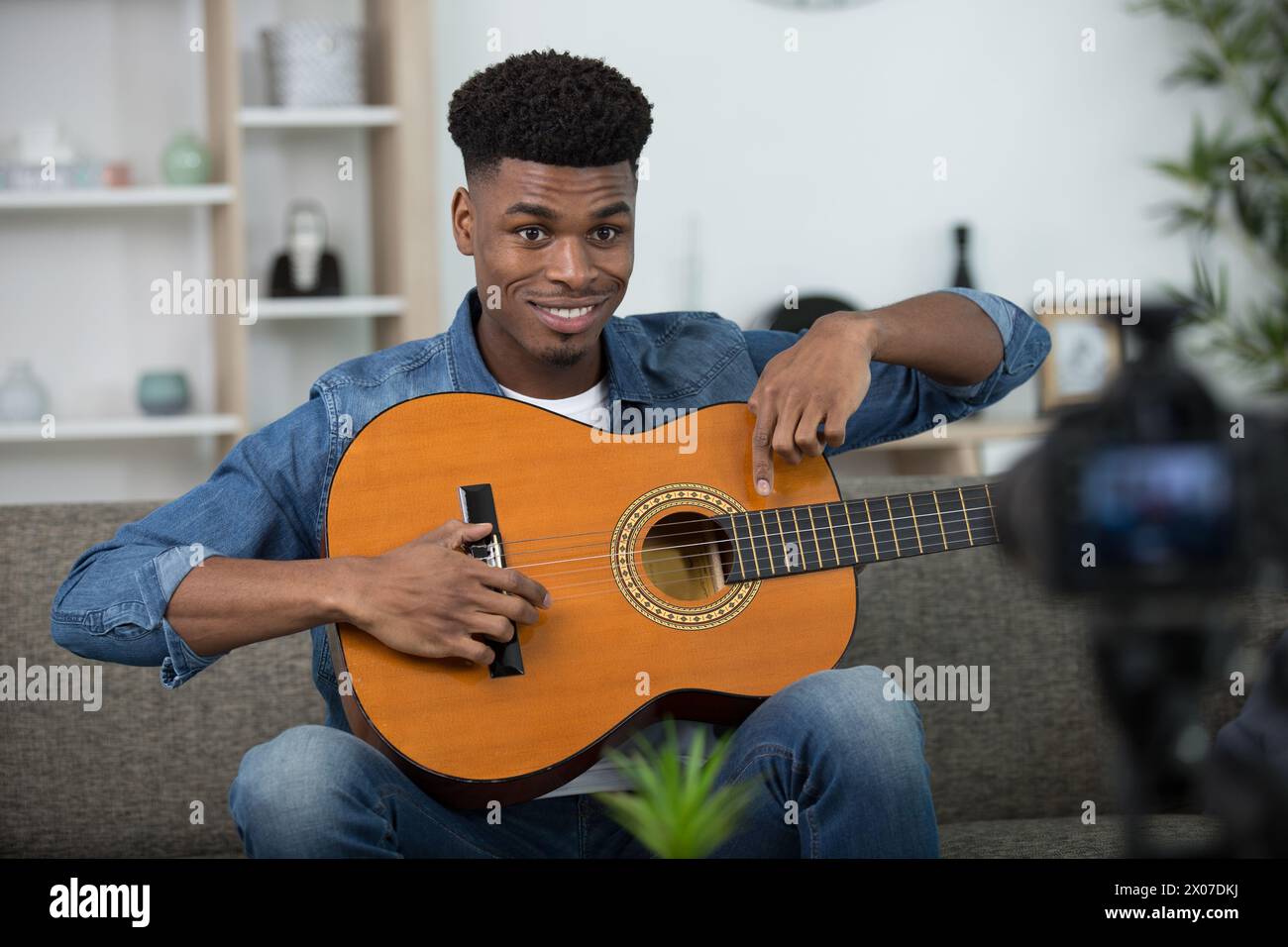 black man using playing guitar at home Stock Photo - Alamy