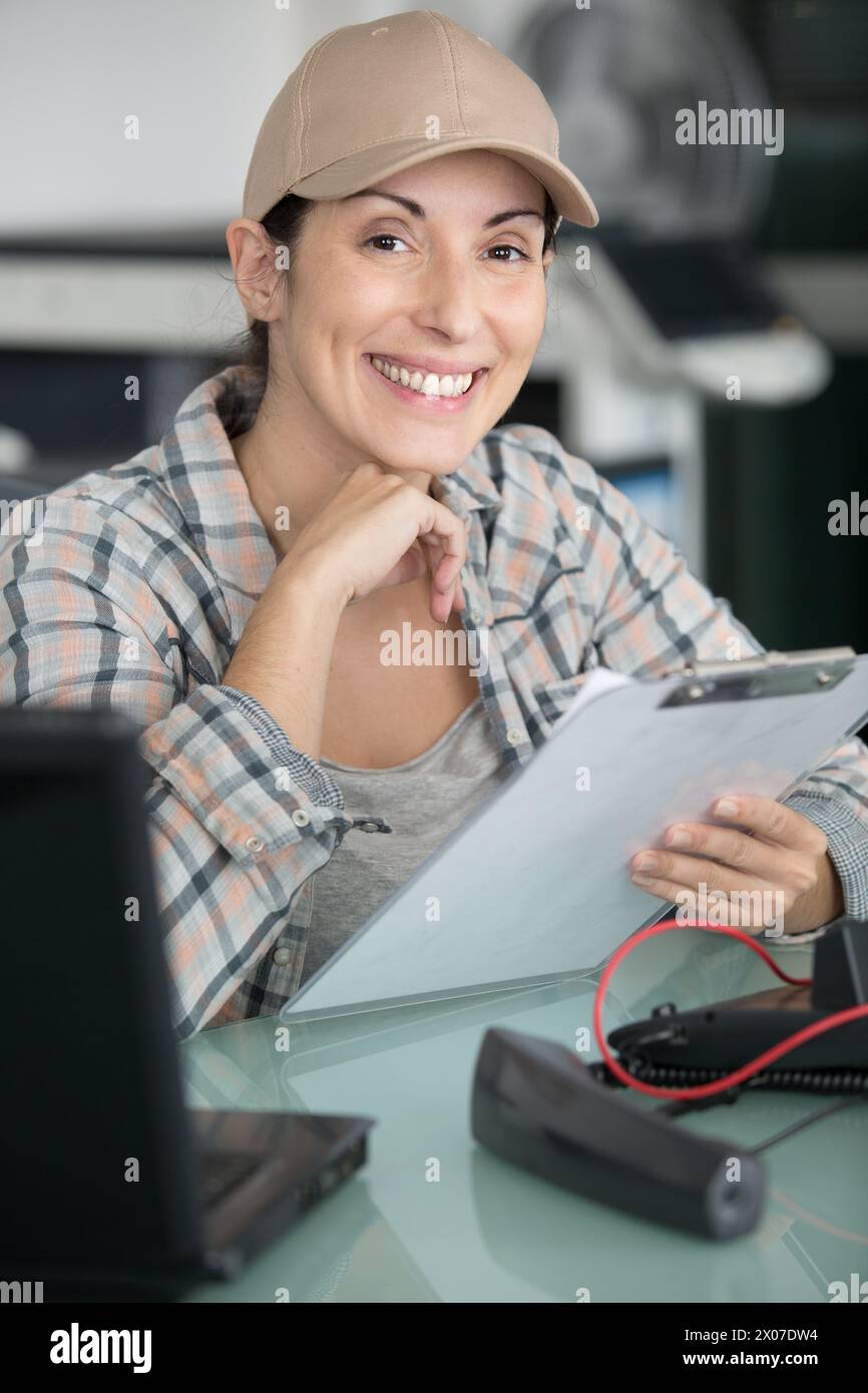 happy technician maintaining record on clipboard Stock Photo